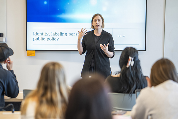 Amy Perry speaks with students during a sociology class at STLCC.