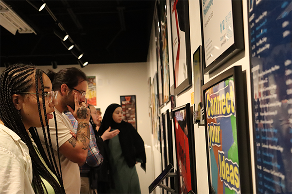 Students viewing art at STLCC gallery width=