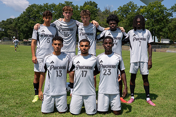 STLCC Archers men’s soccer players pose together on the field. width=