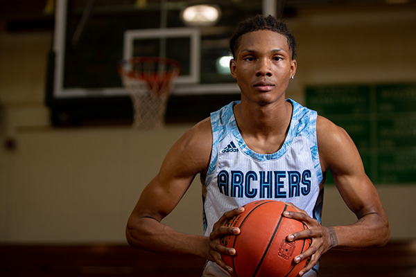 Former Archer Anias Futrell holding a basketball on the court