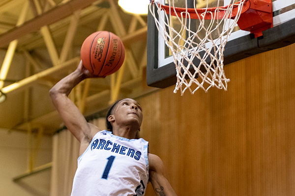 Anias Futrell dunks a basketball in the hoop