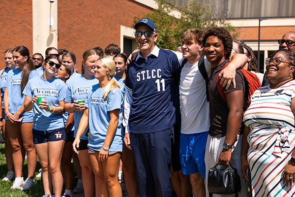 Chancellor Jeff Pittman poses with STLCC faculty and staff while wearing a branded jersey celebrating 11 years of service.