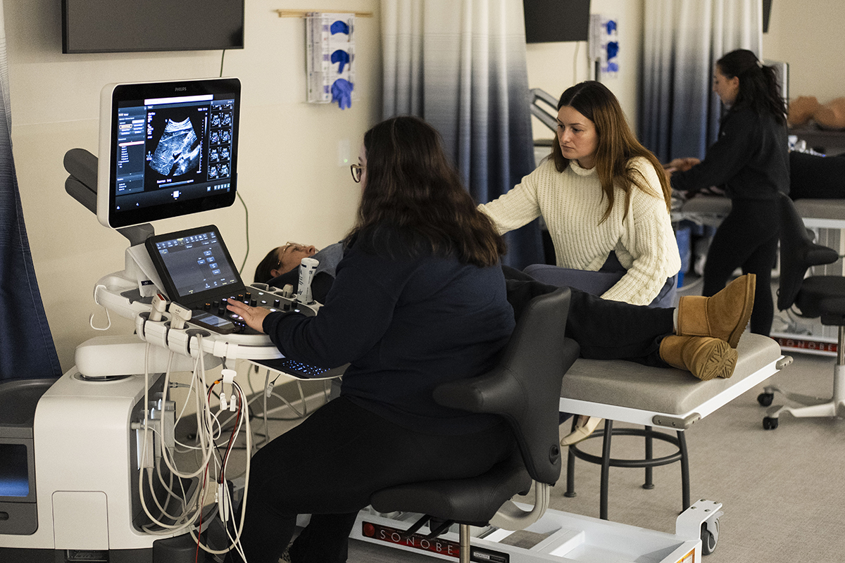 DMS students working with a patient in a clinic