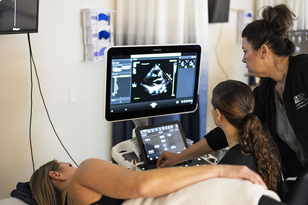 Instructor showing DMS student how to use imaging equipment