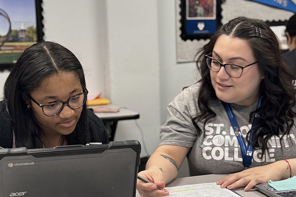 STLCC outreach and recruitment team member working with a high school student width=