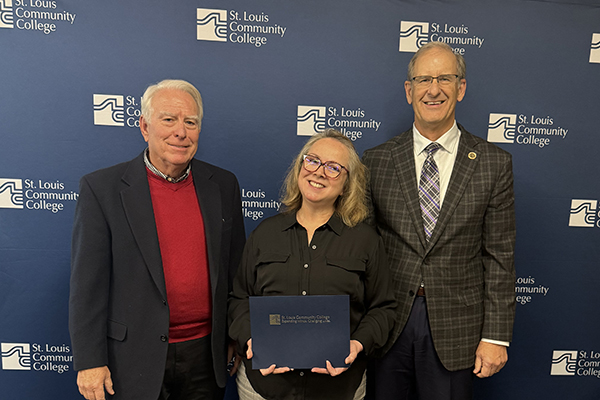 STLCC-Wildwood math professor Kim Granger posing with Chancellor Jeff Pittman after receiving the AMATYC Teaching Excellence Award width=