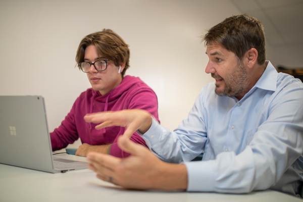 educator instructing student how to use ai for classwork width=