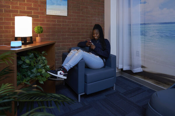 STLCC student reading AI news on her phone width=