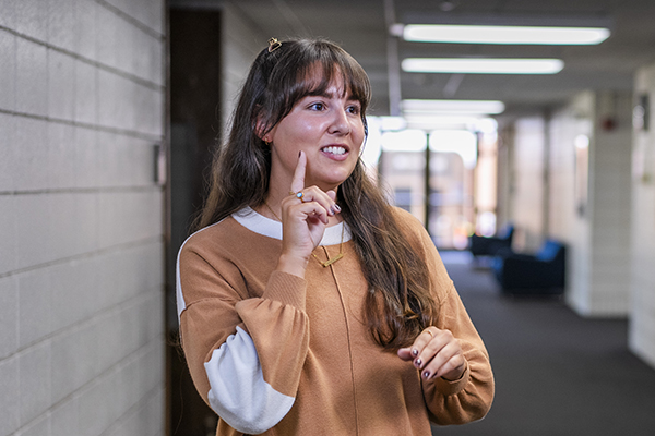 Student using American Sign Language to communicate a signed phrase. width=