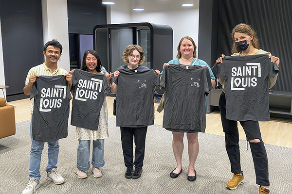 biotech students holding T-shirts from 39 North Trivia Night width=