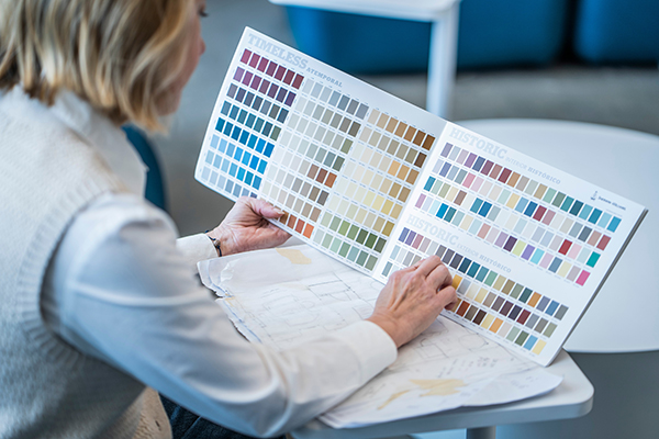 STLCC interior design student reviewing color samples for a design project width=