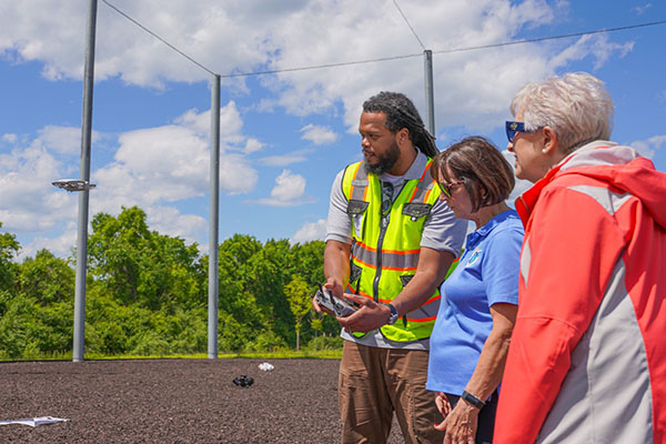 Community members watching a drone demonstration