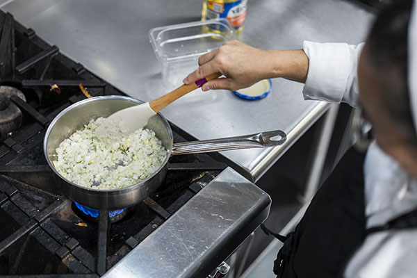 STLCC culinary arts student preparing food in a teaching kitchen