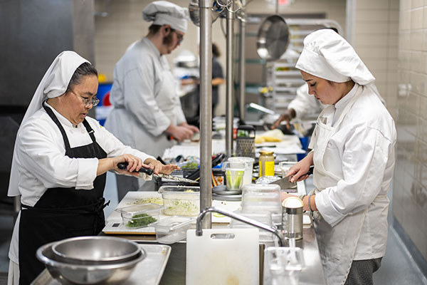 STLCC culinary arts student preparing food in a teaching kitchen