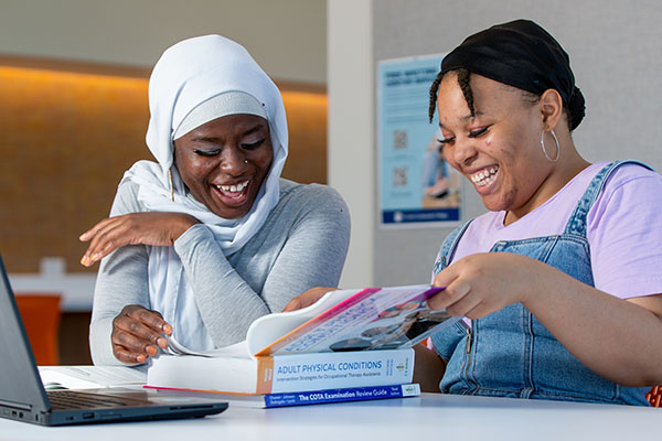 Student buying textbooks width=