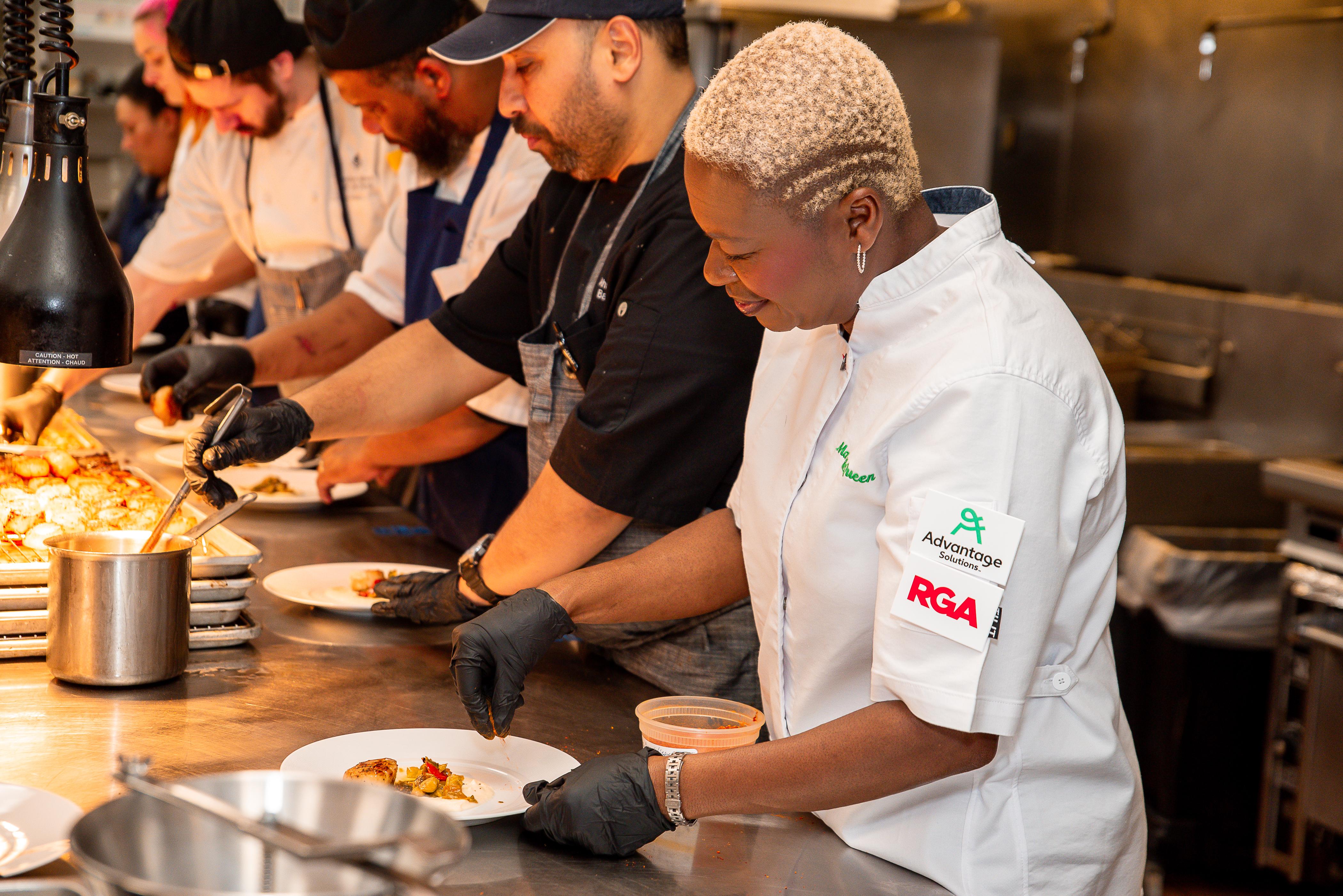 Chef Mawa McQueen in the kitchen preparing a dish for the gala