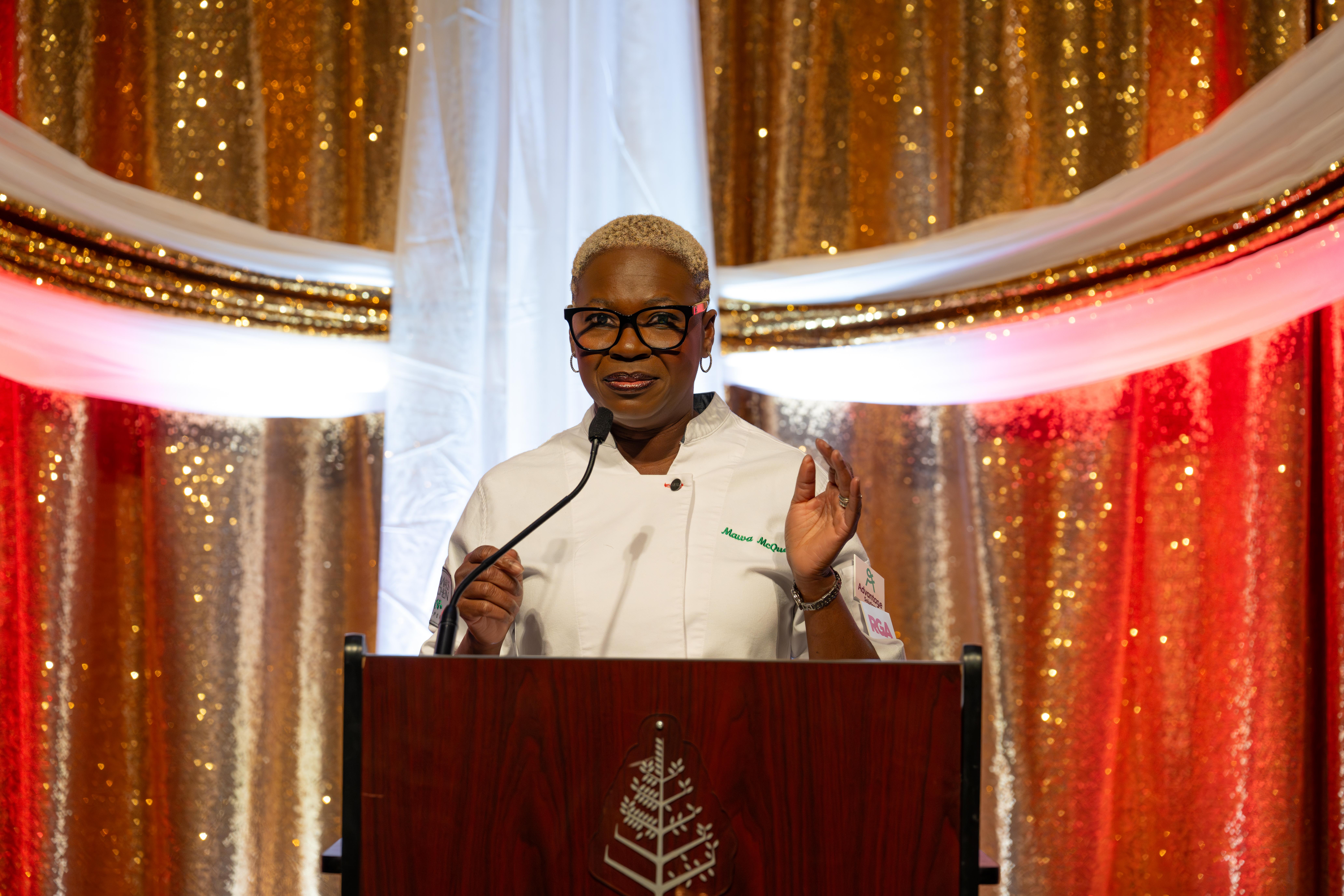 Chef Mawa McQueen speaks at podium