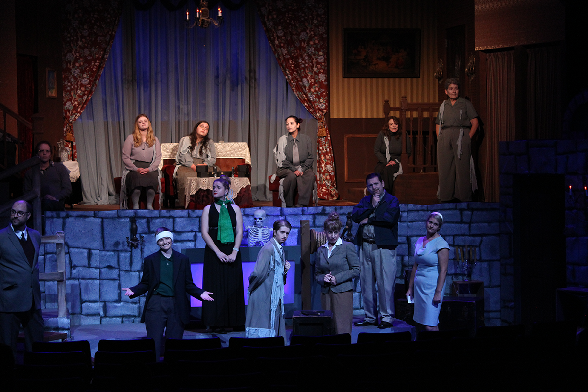 large set with many actors on two levels of stage