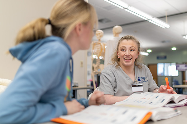 Tutor works with a Wildwood student in a classroom