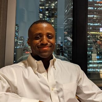 Tony Gee-Salter, a 2015 graduate of St. Louis Community College in culinary arts, sitting in a hotel lobby in downtown Chicago with a view of the skyline at night. 
