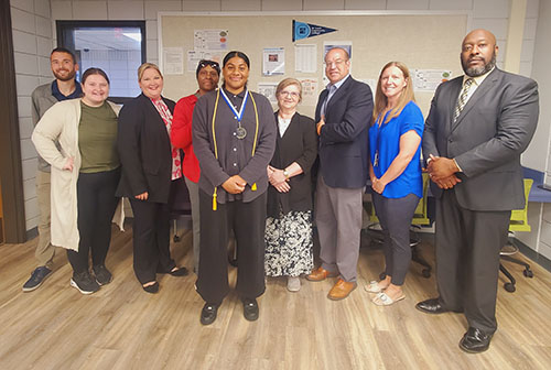 Family and administrators congratulate Nadyah Majeed-Ali, center, and wish her well.