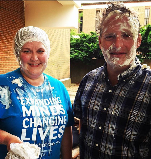 Perkins poses with pie on her face.