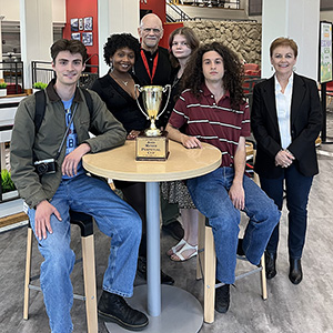 The staff of the Scene with their trophy