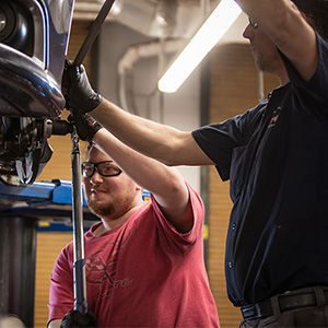 Students performing automotive work