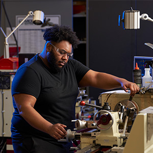 Student using mechanical equipment