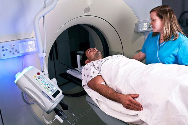 Patient in CT scan machine with tech