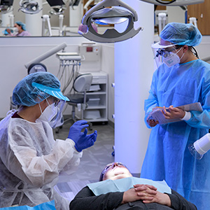 Dental students working with a patient