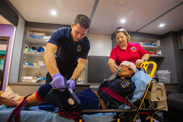 Instructor training a paramedic technology student