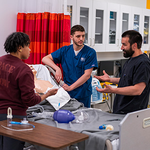 Students demonstrating on patient mannequin