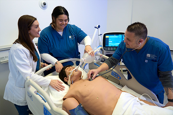 Students in the respiratory care program practicing their skills on a manikin