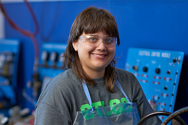 student in science lab with goggles