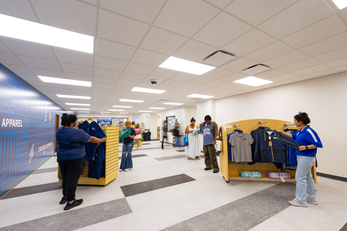 students purchasing course materials and spirit wear at flo valley store