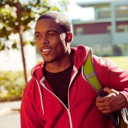 black male student with backpack outside