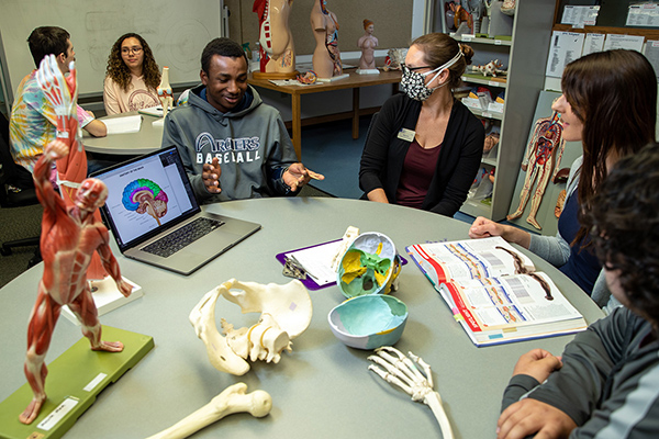 Students sit at a table in a health classroom