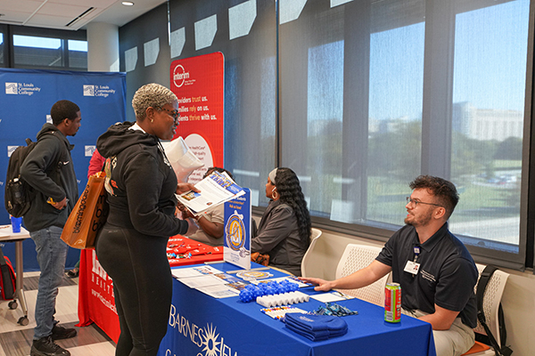 Students connecting with college representatives and employers at STLCC