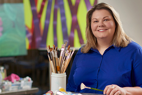 Painting student with brushes