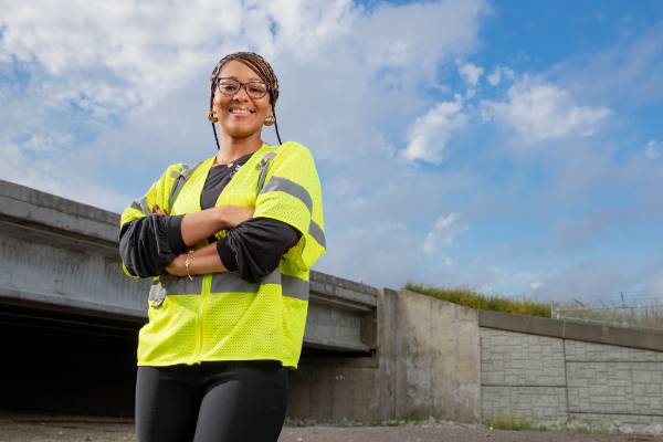 Diamond Cottman poses in front of a bridge she helped engineer