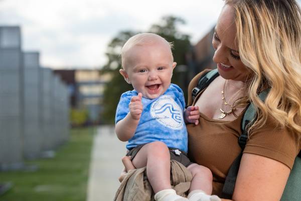 Sawyer is held by his mom on the Forest Park CNHS quad