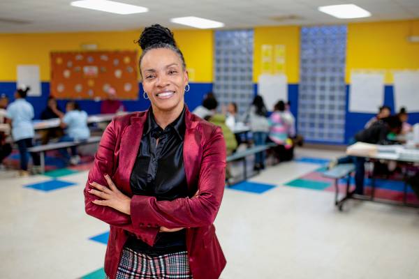 Shawntelle Fisher stands in one of the school cafeterias where her organization's after school tutoring program takes place 