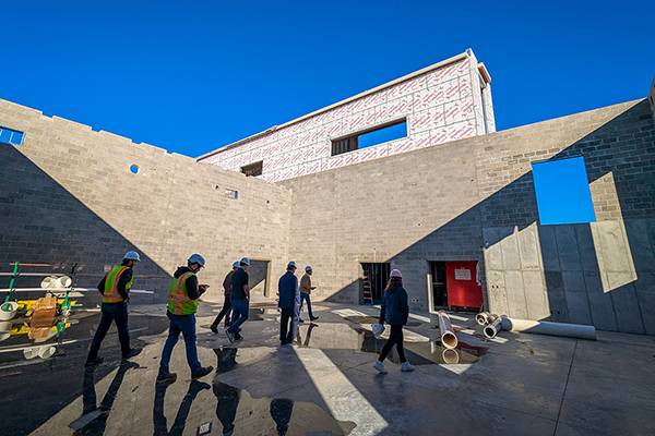 a tour group walks through the space that will become a lab