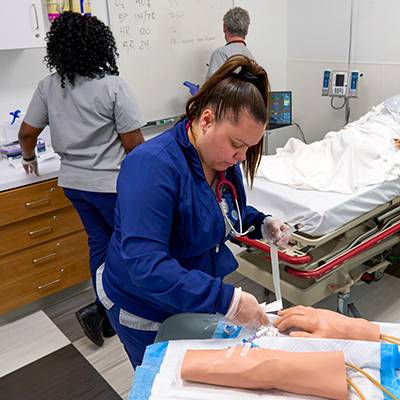 Nursing students practice on mannequins