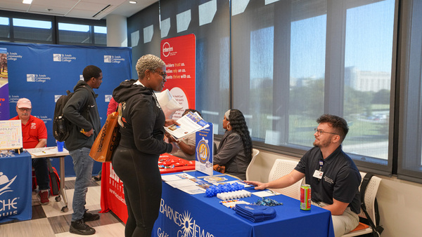 students meeting with employers at career fair event