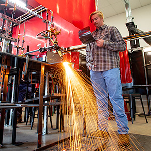 Student learning welding techniques